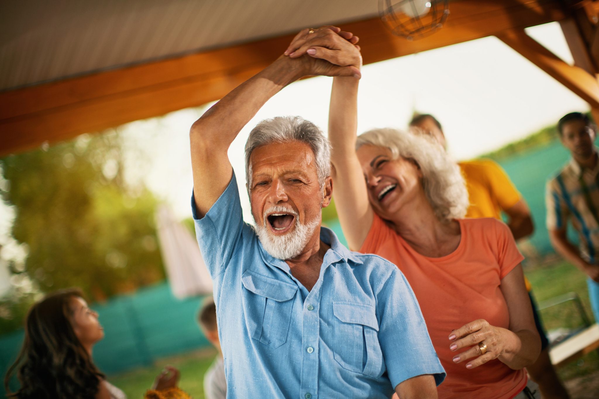 Senior couple dancing at a family party.